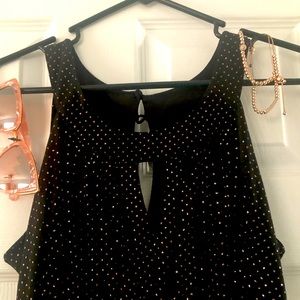 Ankle length black dress w pink with sunglasses and bracelets.